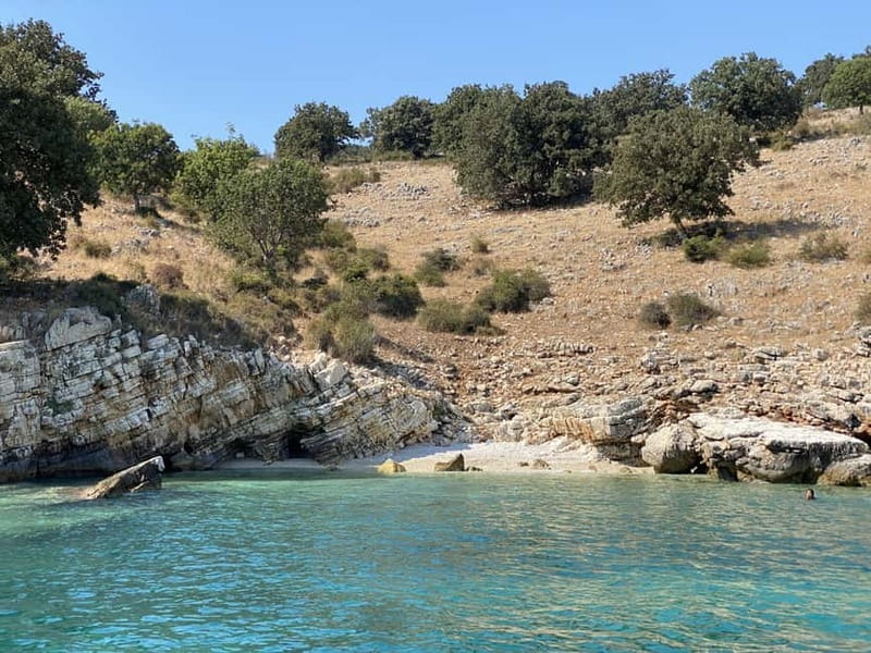 Saranda: Sea Adventure with 7 Stops, Drinks, & Snorkel Fun - Kakome Bay and green hills around the water