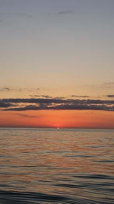 Sarandë: Sunset boat tour with local wine - Sunset at sea with a glass of local wine